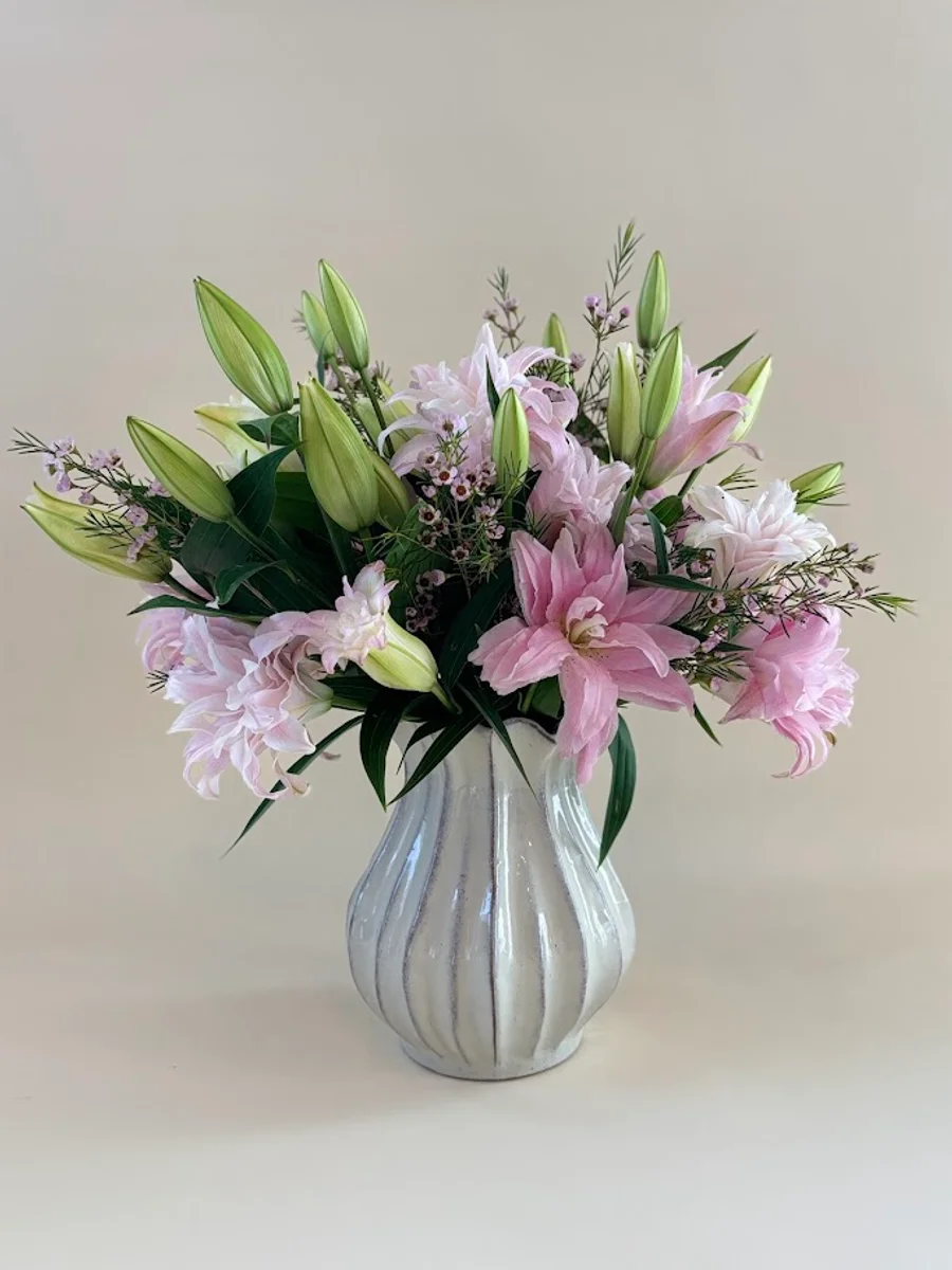 The Camille - soft pink double lily arrangement with wax flowers and wispy greenery