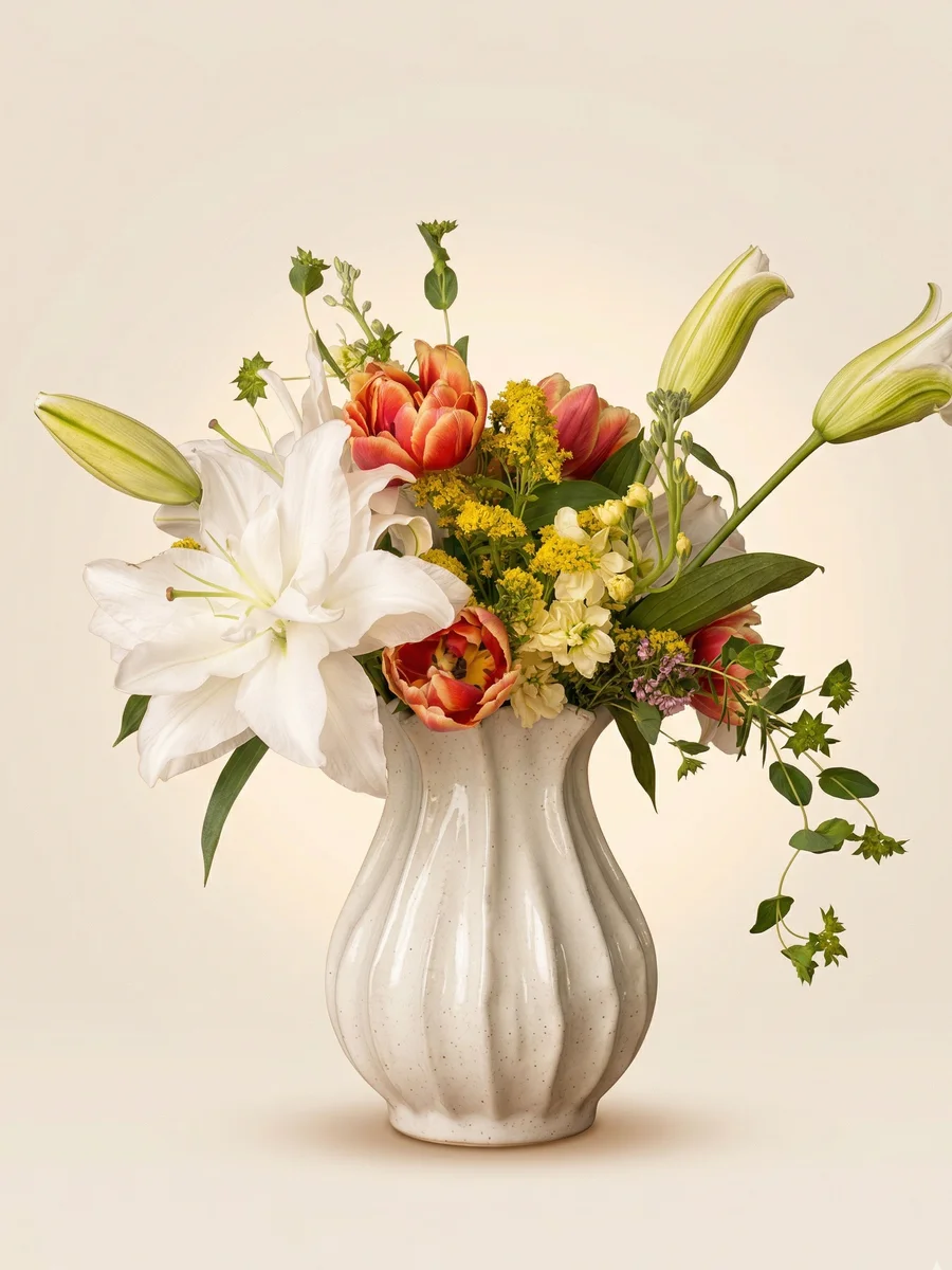 The Clementine - spring flower arrangement with double white lilies, coral parrot tulips, and golden solidago