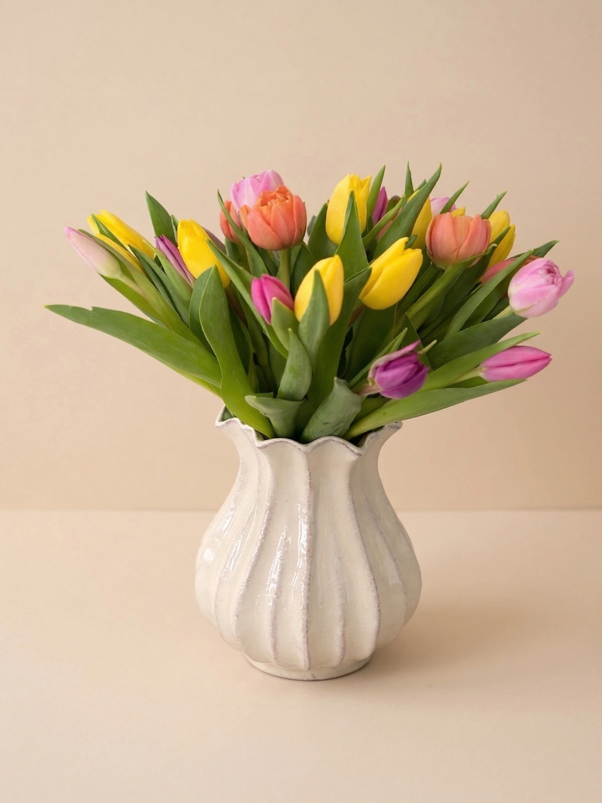 The Eloise - pure spring tulip arrangement in a white scalloped ceramic vase