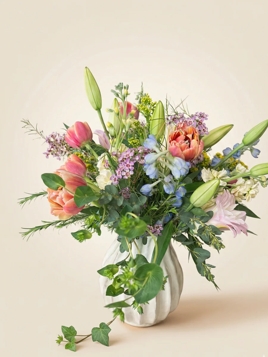 The Rosalind - vibrant birthday flower arrangement with pink lilies, blue delphinium, and yellow stock